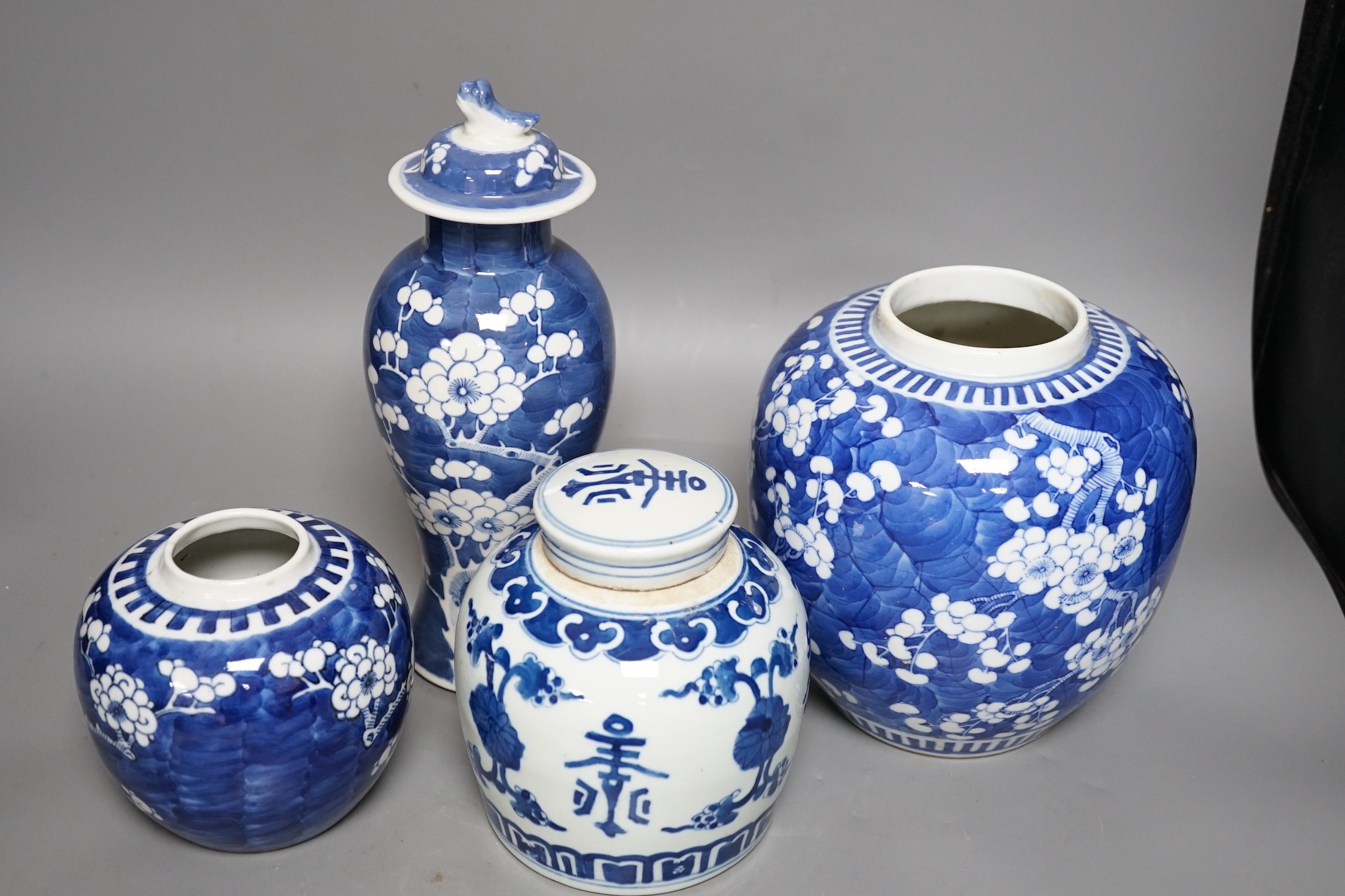 Two Chinese prunus jars, a vase and cover and a a jar and cover, vase and cover 26 cms high